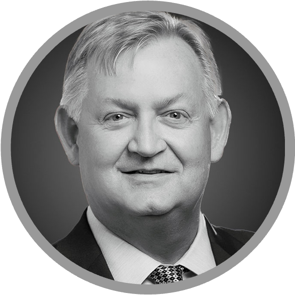 Meet Uniti Wholesale: A grayscale headshot of an older man with light hair, wearing a suit, dress shirt, and patterned tie, smiling at the camera inside a circular frame.