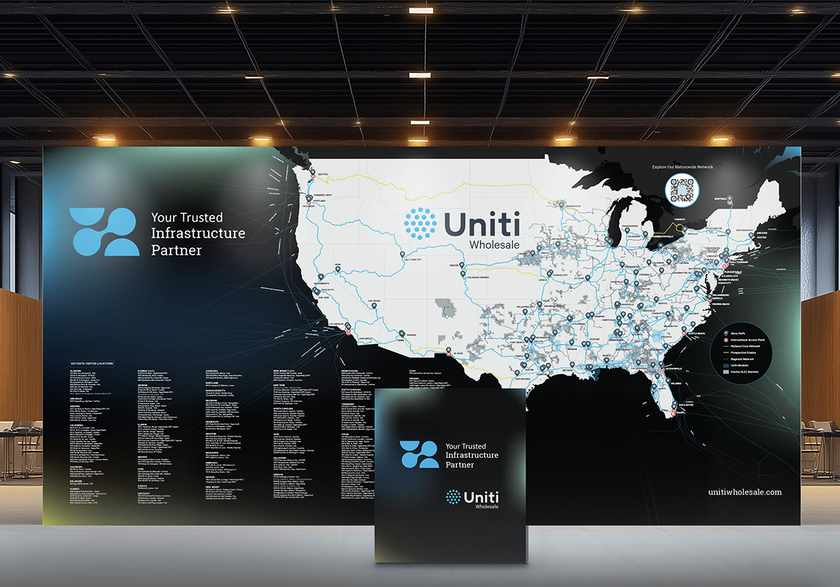 A trade show booth displays a large map of the U.S. with network routes, highlighting Uniti Wholesale. The booth features logos, the slogan "Your Trusted Infrastructure Partner," and a list of locations or partners.